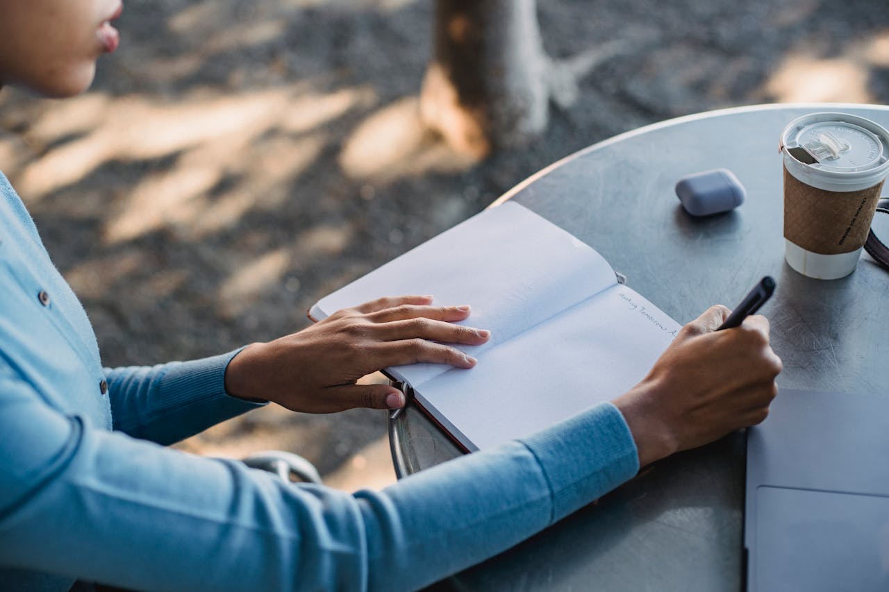 Person journaling at a cafe table deciding between a sabbatical and career break