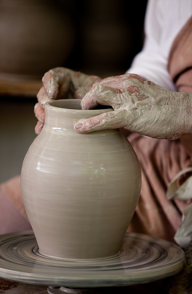 Hands shaping clay on a pottery wheel - one of many creative skills to explore on the road